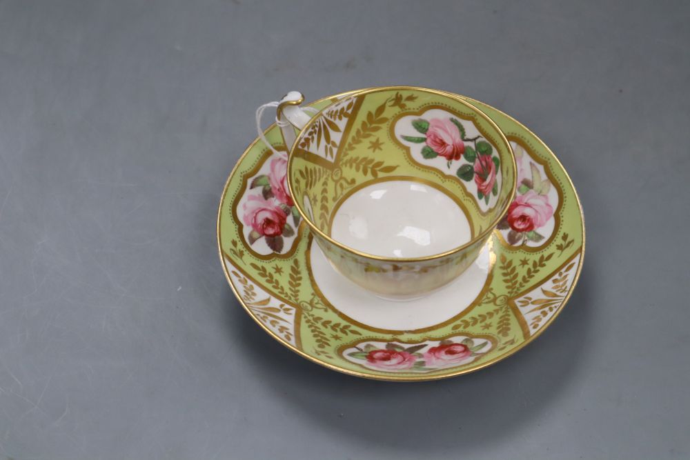 A Spode cup and saucer, painted with pairs of pink rose blooms